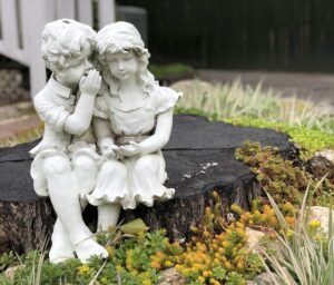 A Fairy Garden with Plants Stump Statue