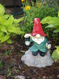 garden gnome sitting with lantern