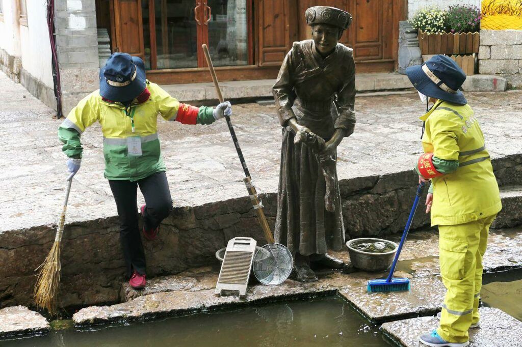 Image by Andrew Barker from Pixabay Workers cleaning up near large bronze statue in China